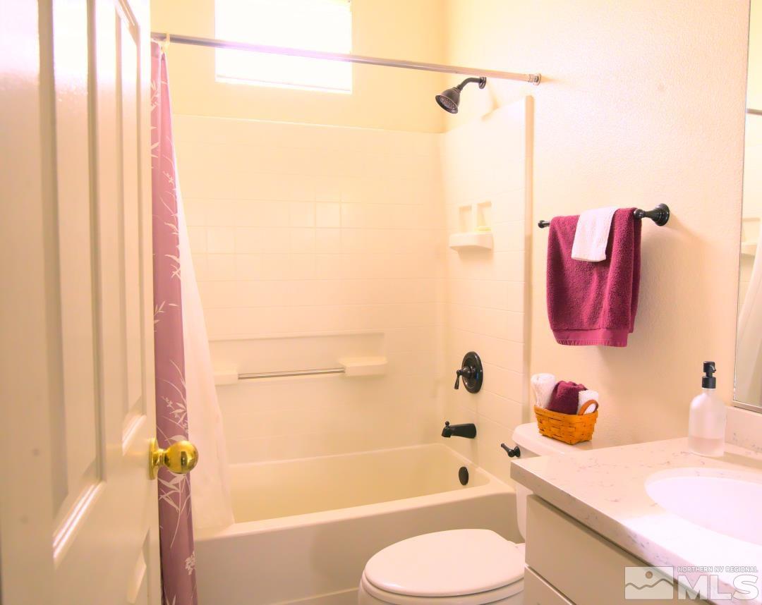 9612 Truckee Meadows Place Reno, NV 89521 - Photo 14 of 29 a bathroom with a sink toilet and shower
