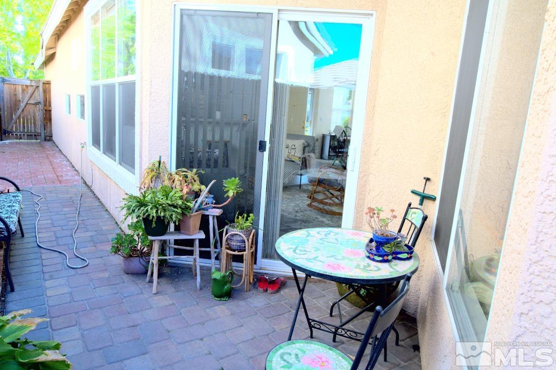 9612 Truckee Meadows Place Reno, NV 89521 - Photo 22 of 29 a backyard of a house with barbeque oven table and chairs