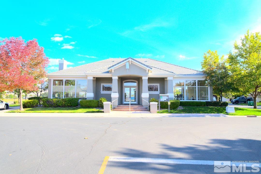 9612 Truckee Meadows Place Reno, NV 89521 - Photo 25 of 29 a front view of a house with a yard and potted plants
