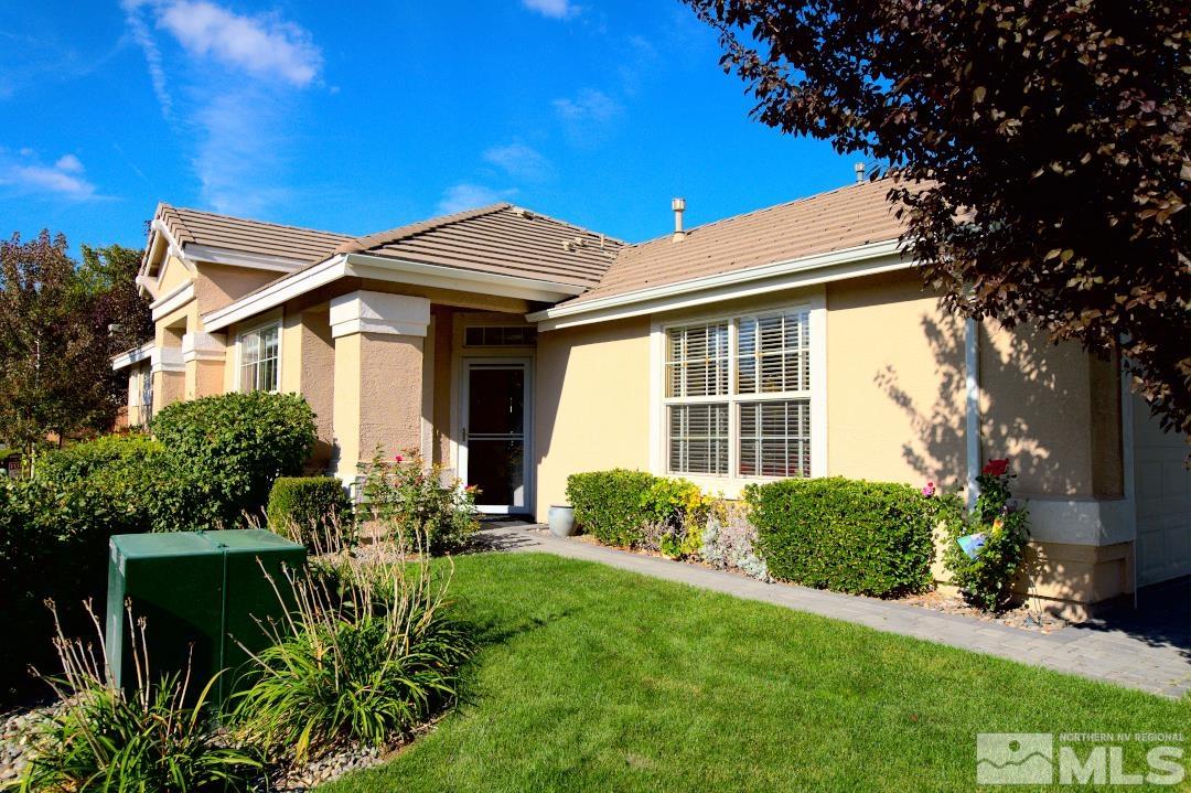 9612 Truckee Meadows Place Reno, NV 89521 - Photo 3 of 29 a front view of a house with a yard