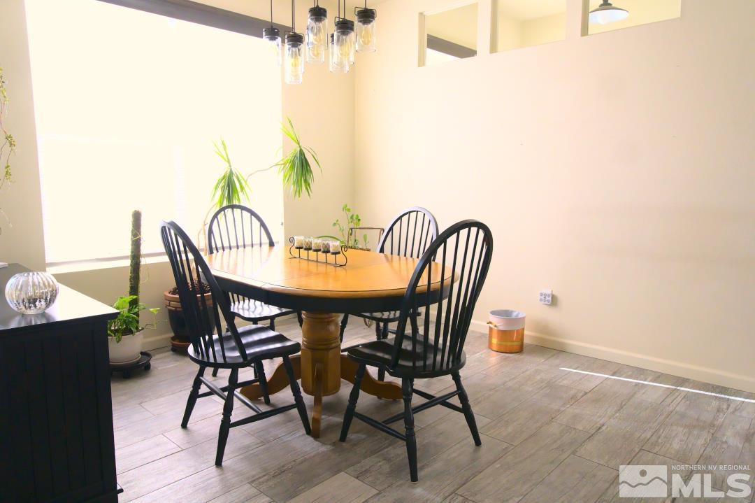 9612 Truckee Meadows Place Reno, NV 89521 - Photo 5 of 29 a view of a dining room with furniture and wooden floor
