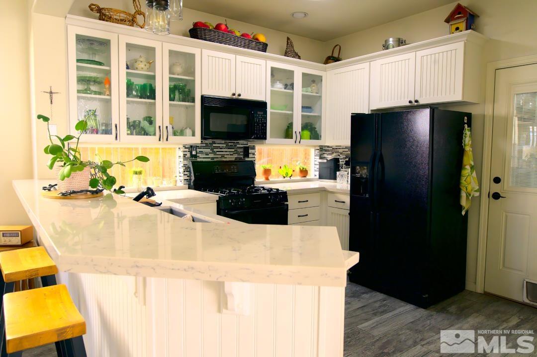 9612 Truckee Meadows Place Reno, NV 89521 - Photo 6 of 29 a kitchen with stainless steel appliances kitchen island granite countertop a refrigerator a stove top oven a sink and dishwasher
