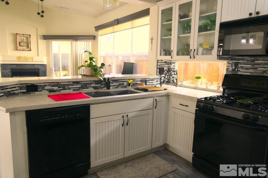 9612 Truckee Meadows Place Reno, NV 89521 - Photo 7 of 29 a kitchen with a stove a sink and a microwave