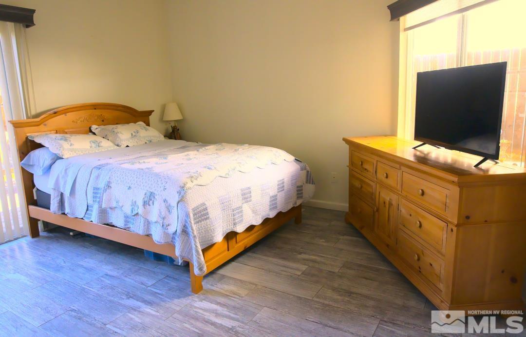 9612 Truckee Meadows Place Reno, NV 89521 - Photo 9 of 29 a bedroom with a bed and flat screen tv