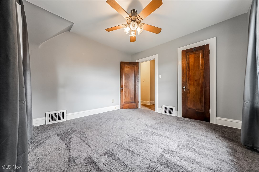 11703 Granger Road Cleveland, OH 44125 - Photo 32 of 41 Unfurnished bedroom with a ceiling fan and carpet flooring