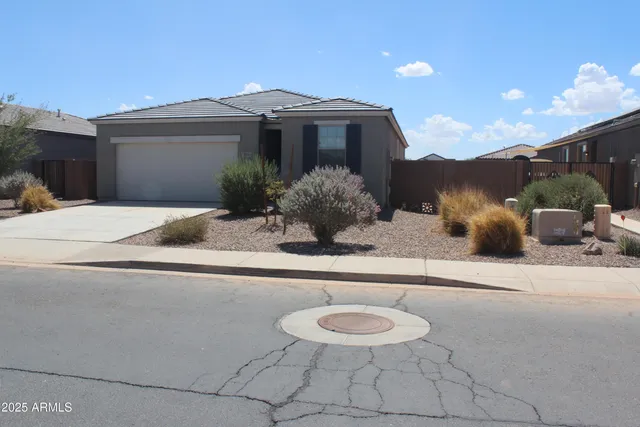 a view of a house with a yard and sitting area