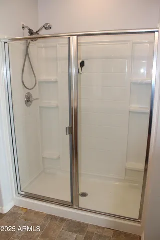 a view of walk in closet with empty racks