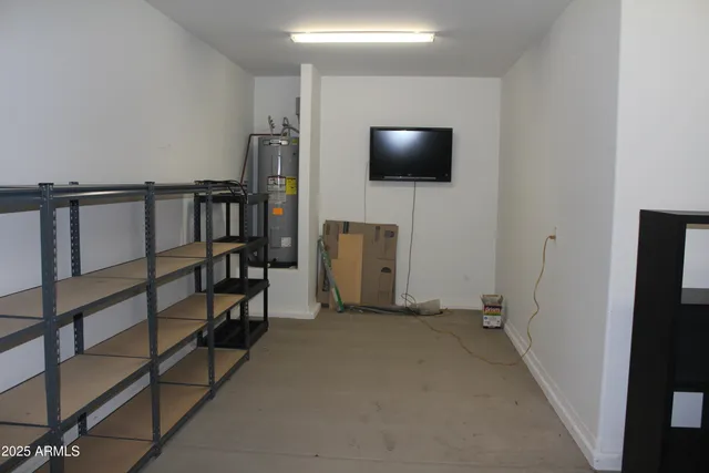 a view of a room that has a couch and a dresser in it