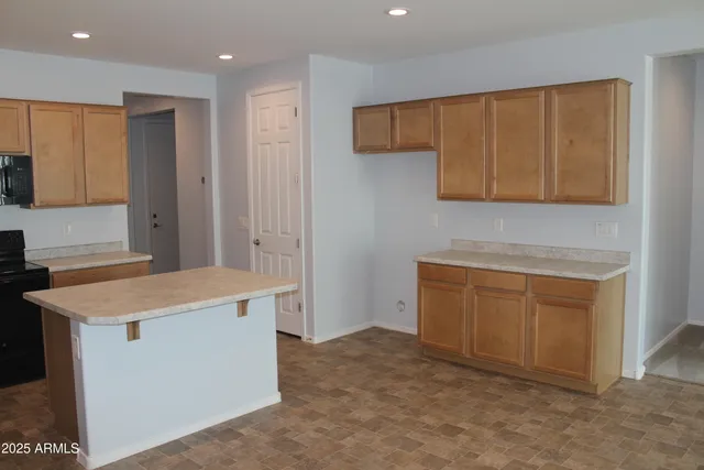 a kitchen with a sink a counter top space stainless steel appliances and cabinets