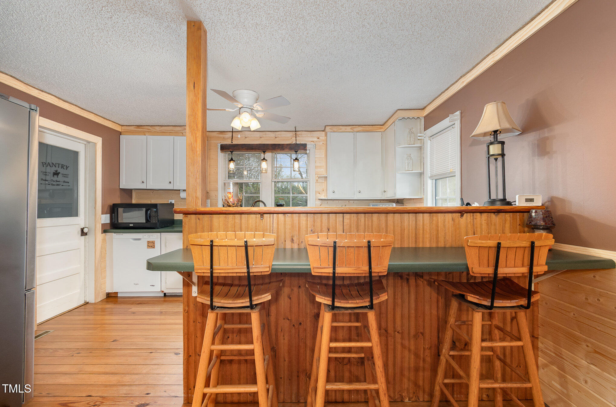 472 Jesse Phillips Road Robbins, NC 27325 - Photo 11 of 36 a kitchen with stainless steel appliances kitchen island granite countertop a table and chairs in it