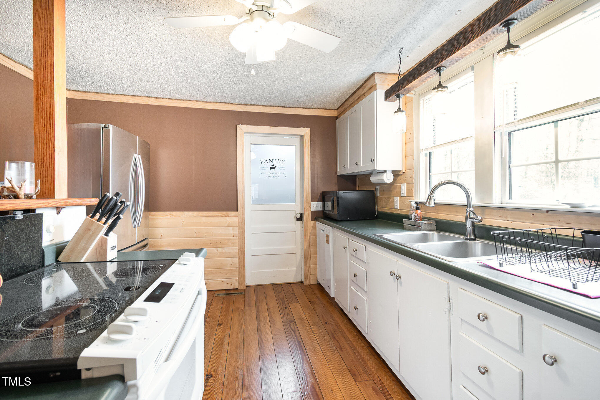 472 Jesse Phillips Road Robbins, NC 27325 - Photo 14 of 36 a large kitchen with granite countertop a large window sink and stainless steel appliances