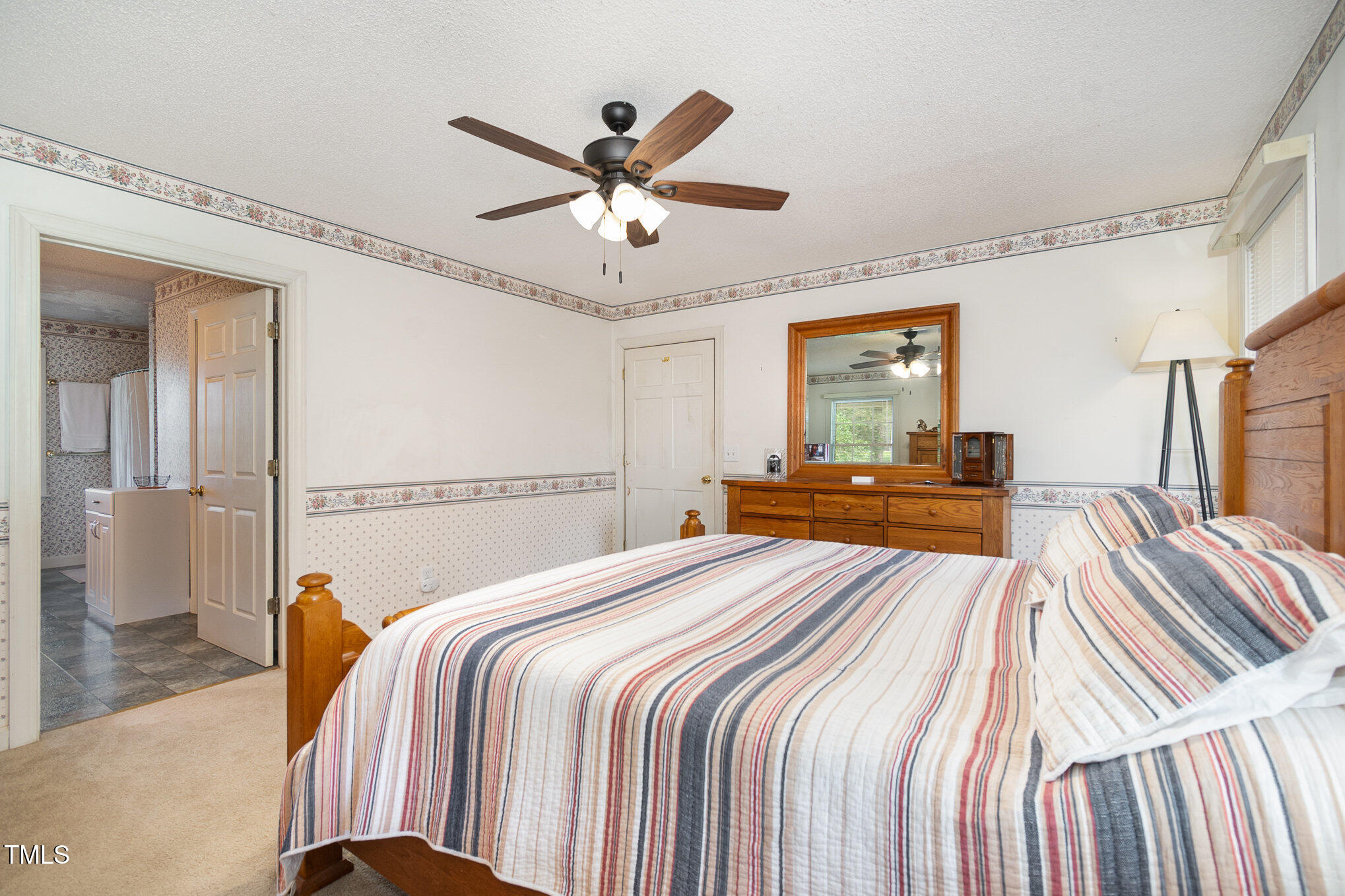 472 Jesse Phillips Road Robbins, NC 27325 - Photo 19 of 36 a bedroom with a large bed and a chandelier