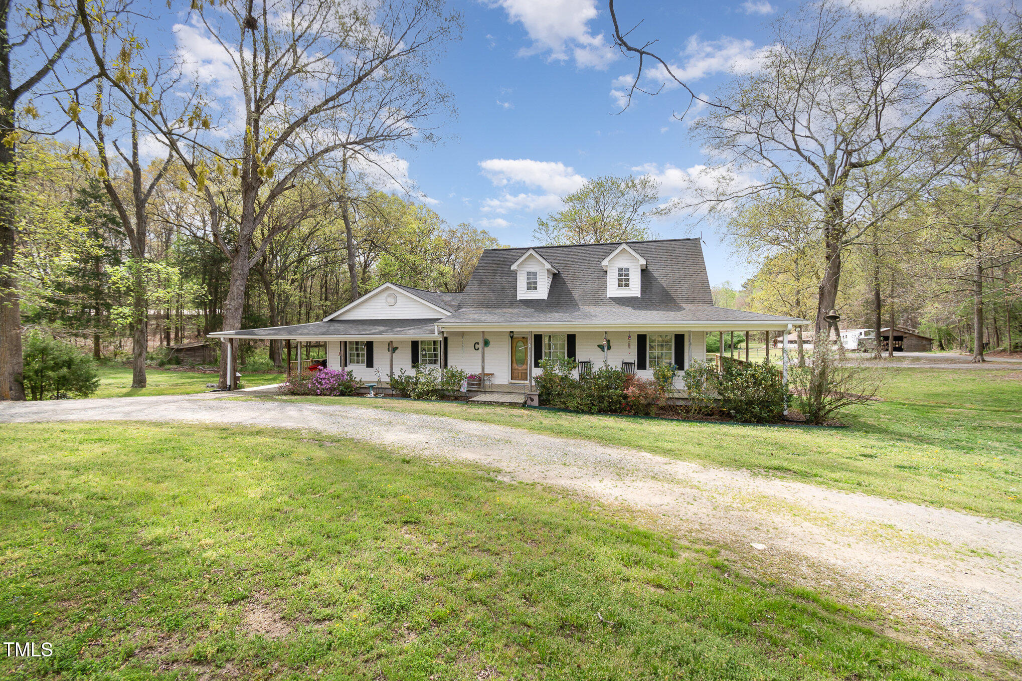 472 Jesse Phillips Road Robbins, NC 27325 - Photo 2 of 36 a front view of a house with a garden