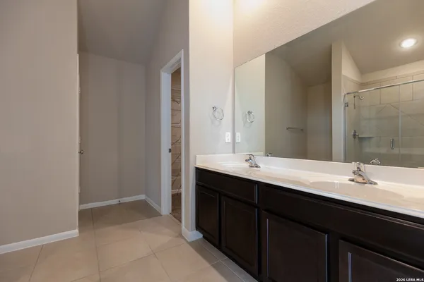 a bathroom with a double vanity sink mirror and double