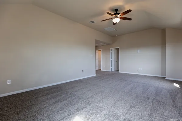 a view of a room with a ceiling fan and a window