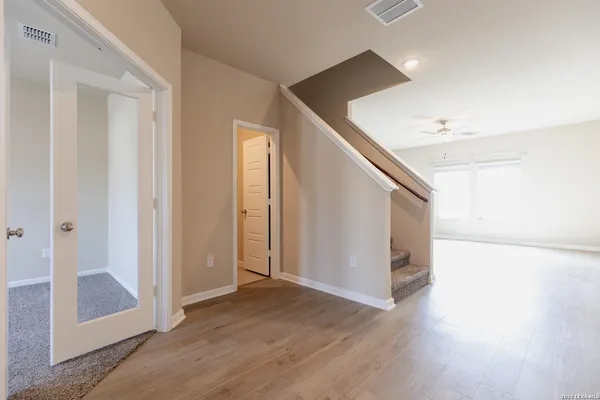 a view of a hallway with wooden floor