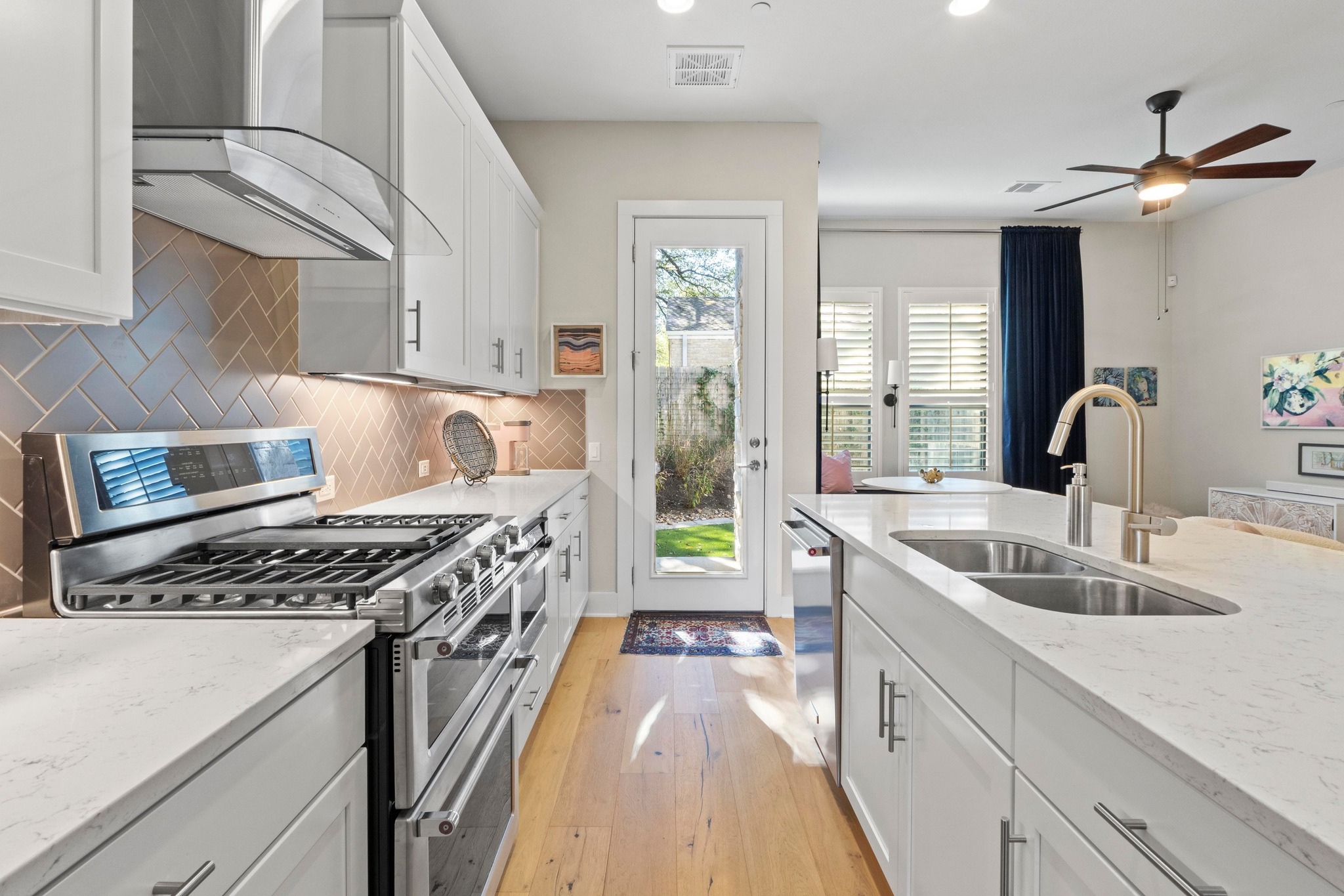 4323 Spicewood Springs Road, Unit 6 Austin, TX 78759 - Photo 12 of 40 Kitchen featuring stainless steel appliances, white cabinetry, wall chimney exhaust hood, and recessed lighting
