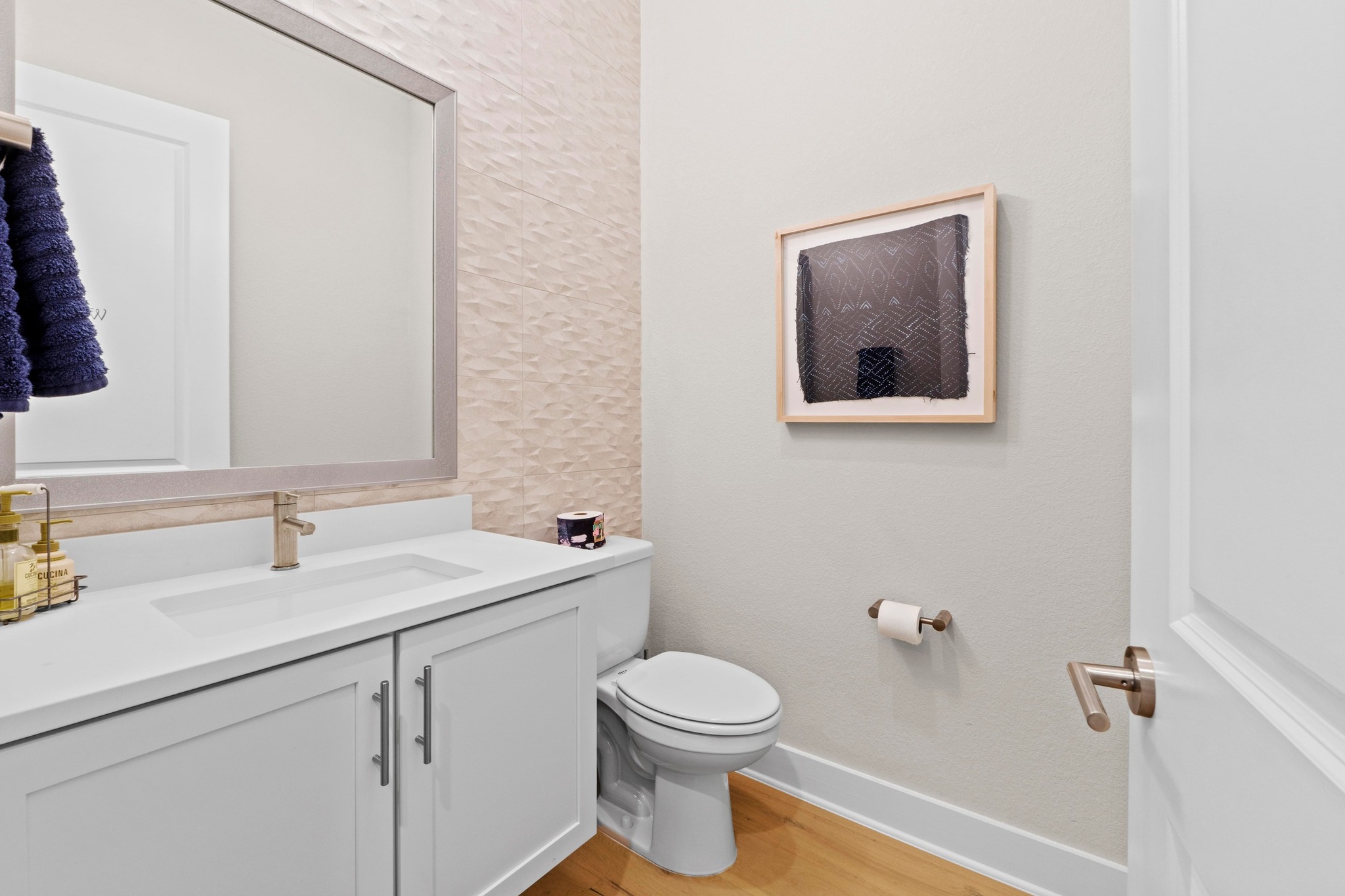 4323 Spicewood Springs Road, Unit 6 Austin, TX 78759 - Photo 18 of 40 1/2 Bathroom on the main level featuring vanity and light wood-type flooring