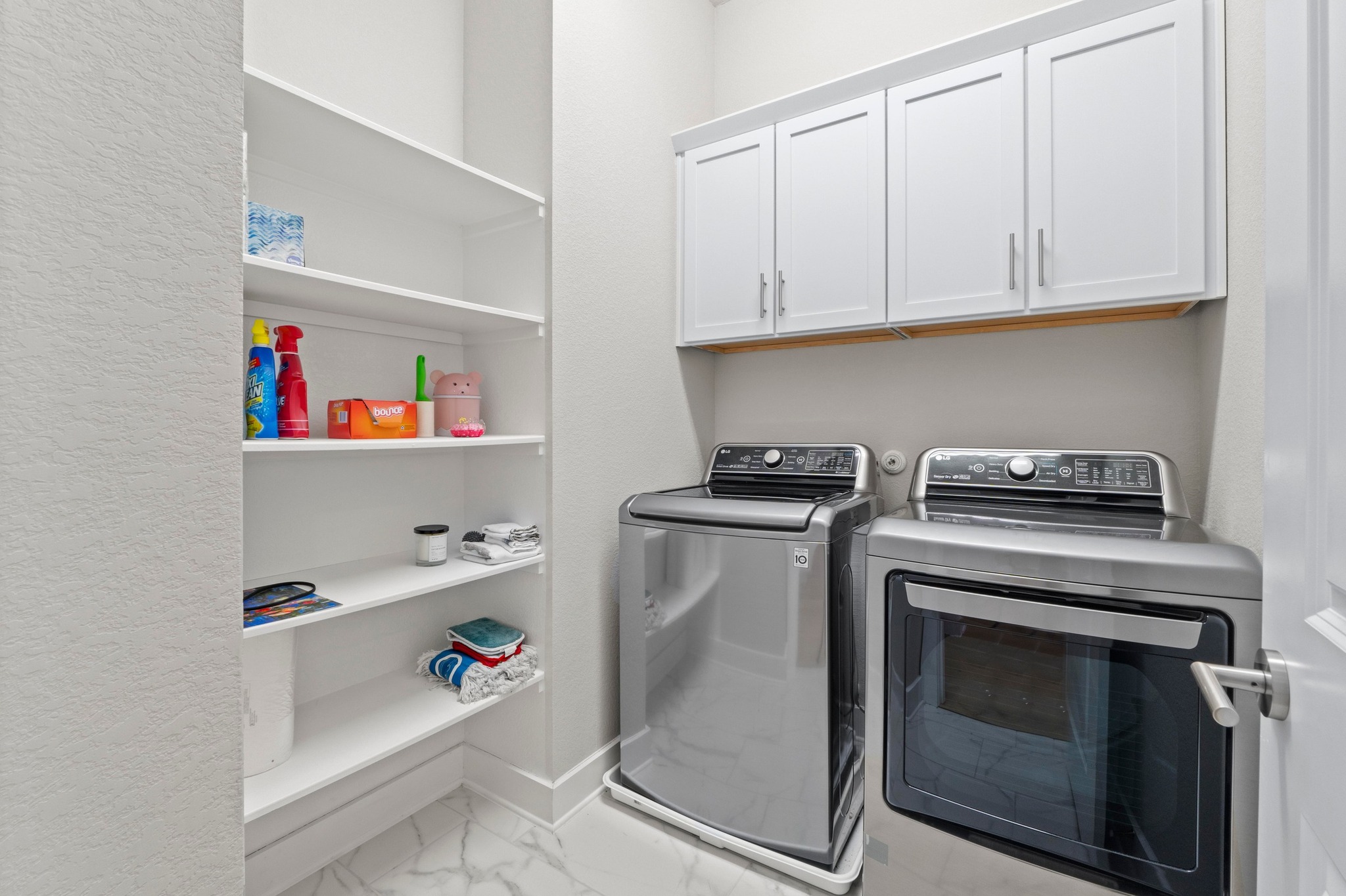 4323 Spicewood Springs Road, Unit 6 Austin, TX 78759 - Photo 36 of 40 Laundry room on second floor with light marble finish floors, independent washer and dryer, and cabinet space