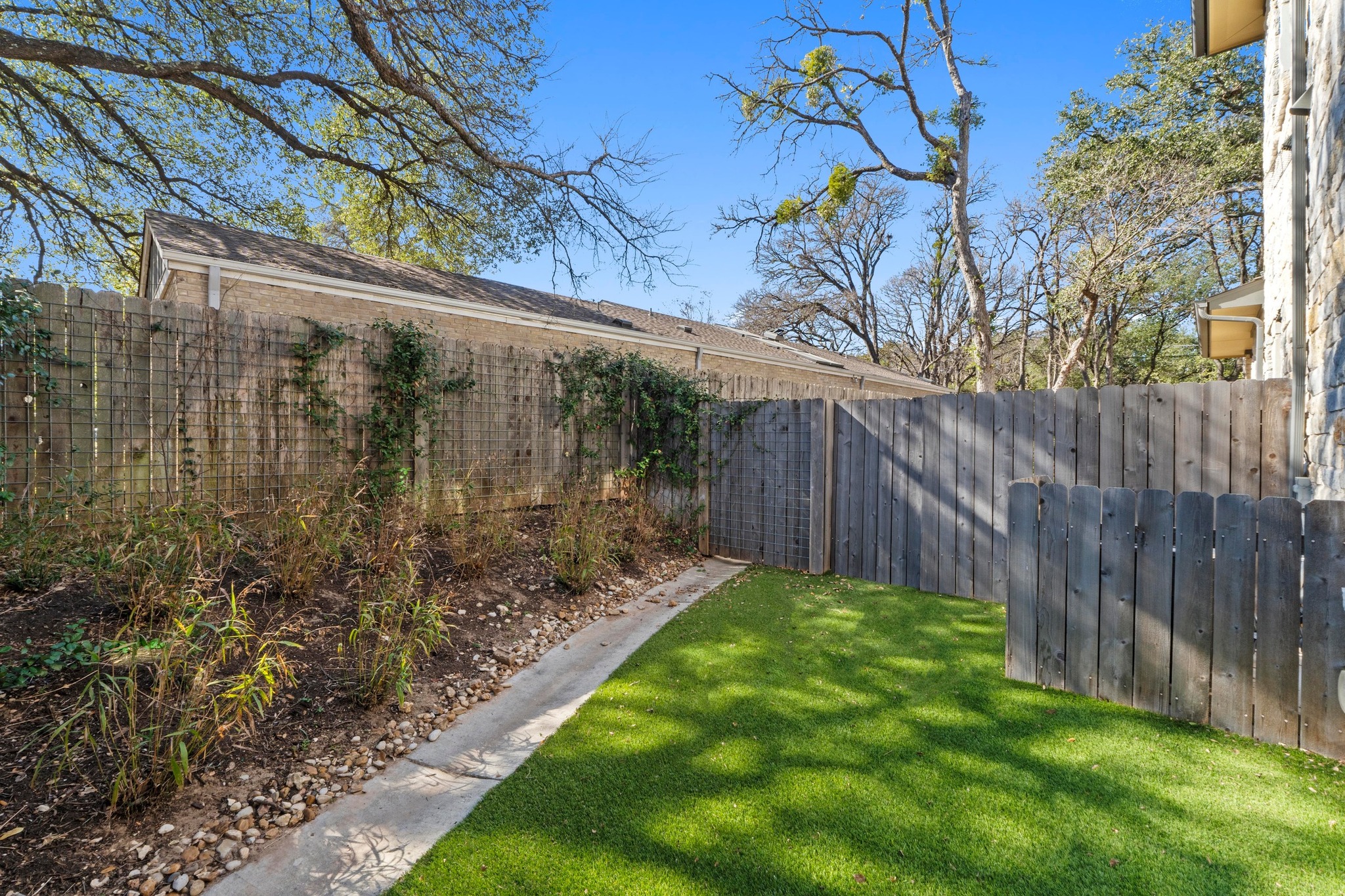 4323 Spicewood Springs Road, Unit 6 Austin, TX 78759 - Photo 37 of 40 View of fenced backyard with turf