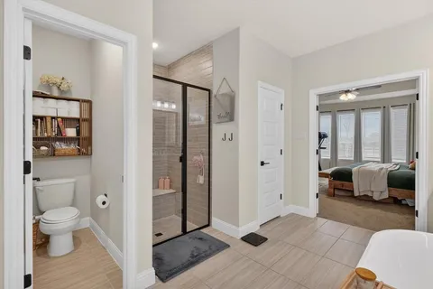 a spacious bedroom with a bed and a couch