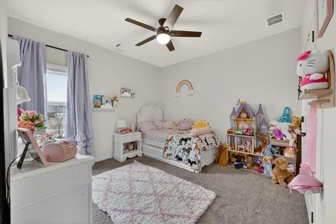 a bedroom with bed and a chandelier