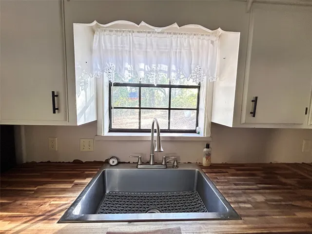 front view of a house with a yard and an trees