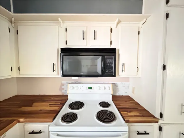 a view of a wooden house with a large tree
