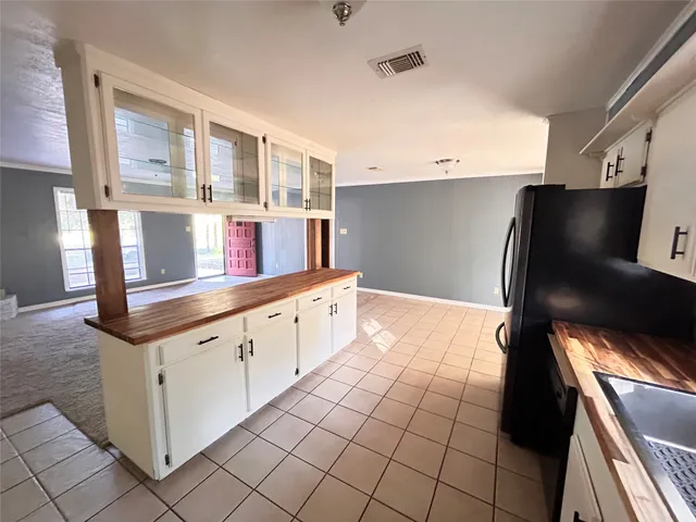 front view of a house with a large tree