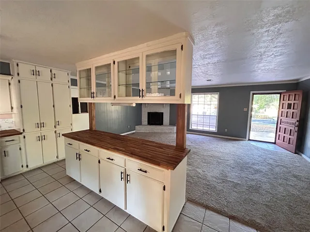 a kitchen with granite countertop a sink a stove and cabinets