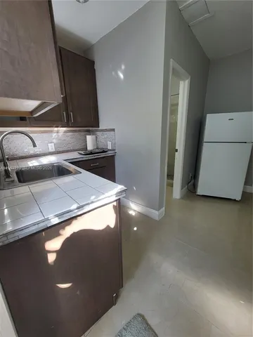 a view of a kitchen with a refrigerator and a stove