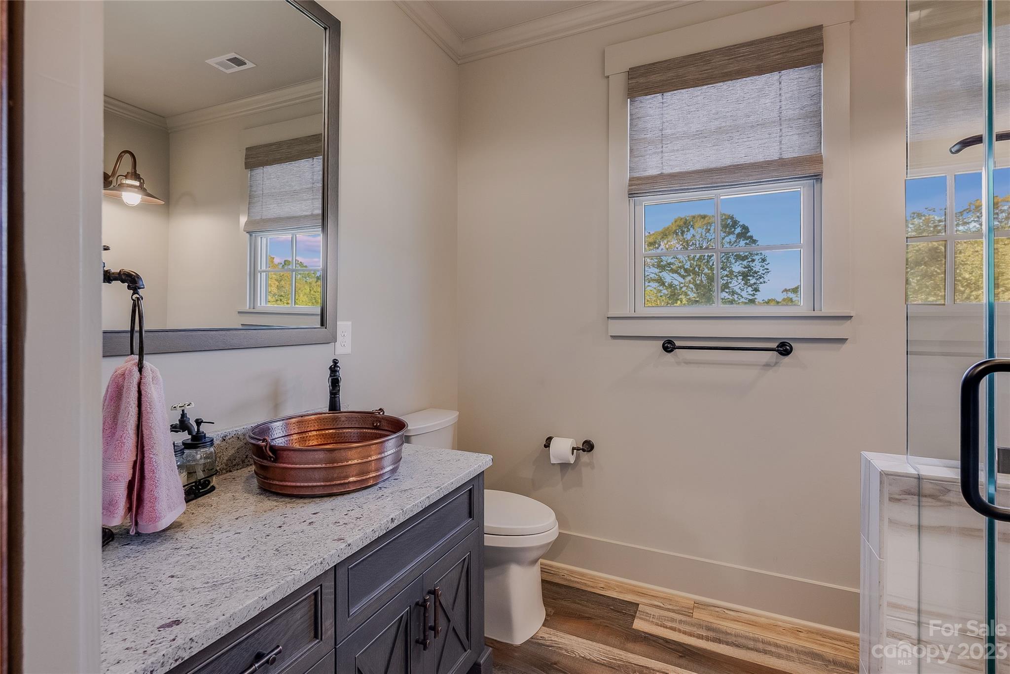 1416 Barbee Road Shelby, NC 28150 - Photo 26 of 41 a bathroom with a granite countertop sink a toilet and a mirror