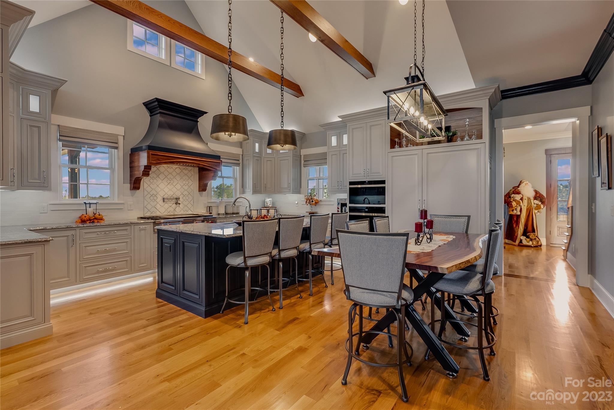 1416 Barbee Road Shelby, NC 28150 - Photo 4 of 41 a kitchen with stainless steel appliances kitchen island granite countertop a table chairs in it and a wooden floors