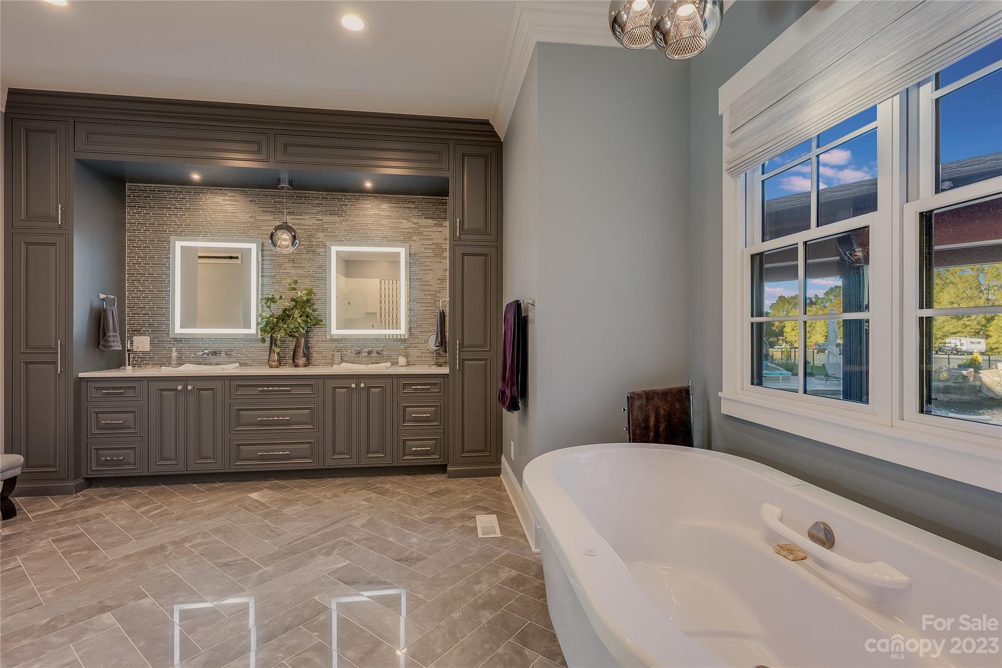 1416 Barbee Road Shelby, NC 28150 - Photo 9 of 41 a bathroom with a tub a double vanity sink and a large mirror