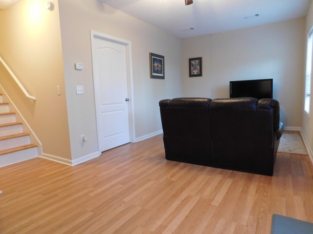 105 Benton Road Juliette, GA 31046 - Photo 11 of 19 a living room with wooden floor and black ceiling fan