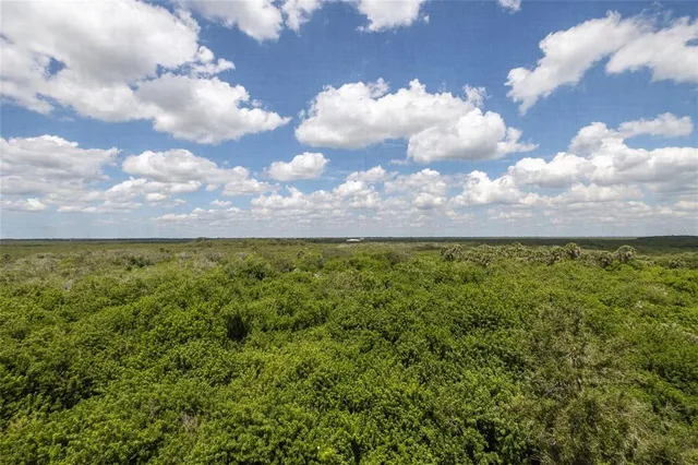 a spacious bedroom with a bed and wooden floor