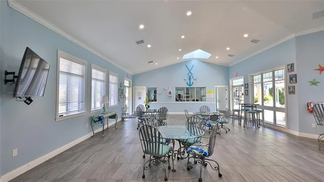 a view of a patio with couches table and chairs potted plants and palm tree