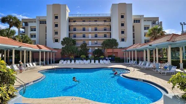 a view of a building with swimming pool and sitting area