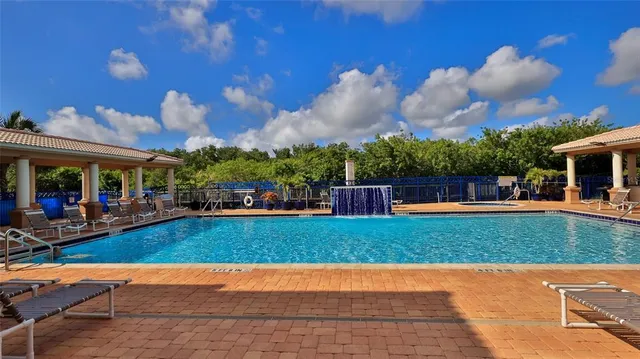 a large kitchen with kitchen island a large counter space cabinets and furniture