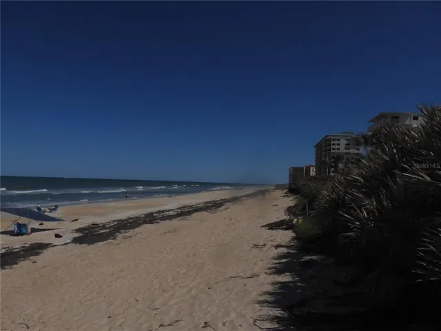 a view of a kitchen with a sink and wooden floor