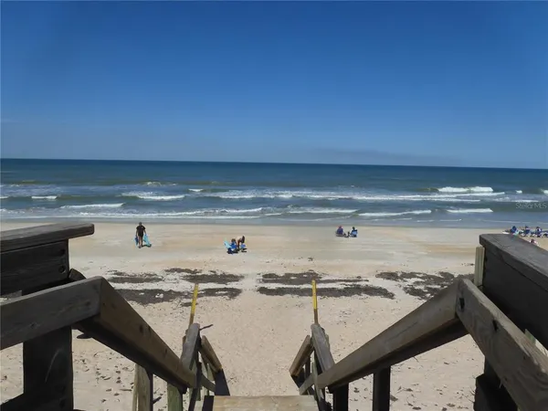 a sign board with buildings in the background