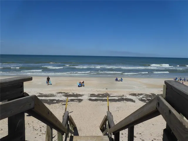 a sign board with buildings in the background