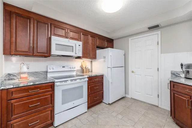 a dining room with furniture and a floor to ceiling window