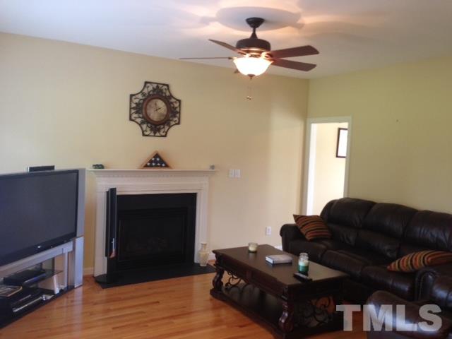 1004 Nortonbridge Road Raleigh, NC 27603 - Photo 4 of 13 a living room with furniture and a fireplace