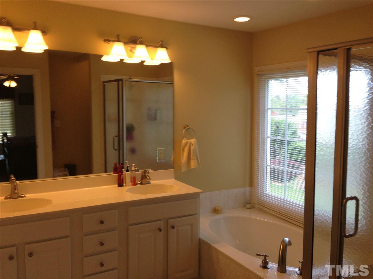 1004 Nortonbridge Road Raleigh, NC 27603 - Photo 8 of 13 a bathroom with a bathtub and a sink