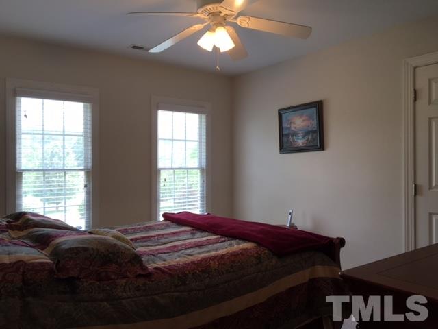 1004 Nortonbridge Road Raleigh, NC 27603 - Photo 9 of 13 a bedroom with a bed and a window