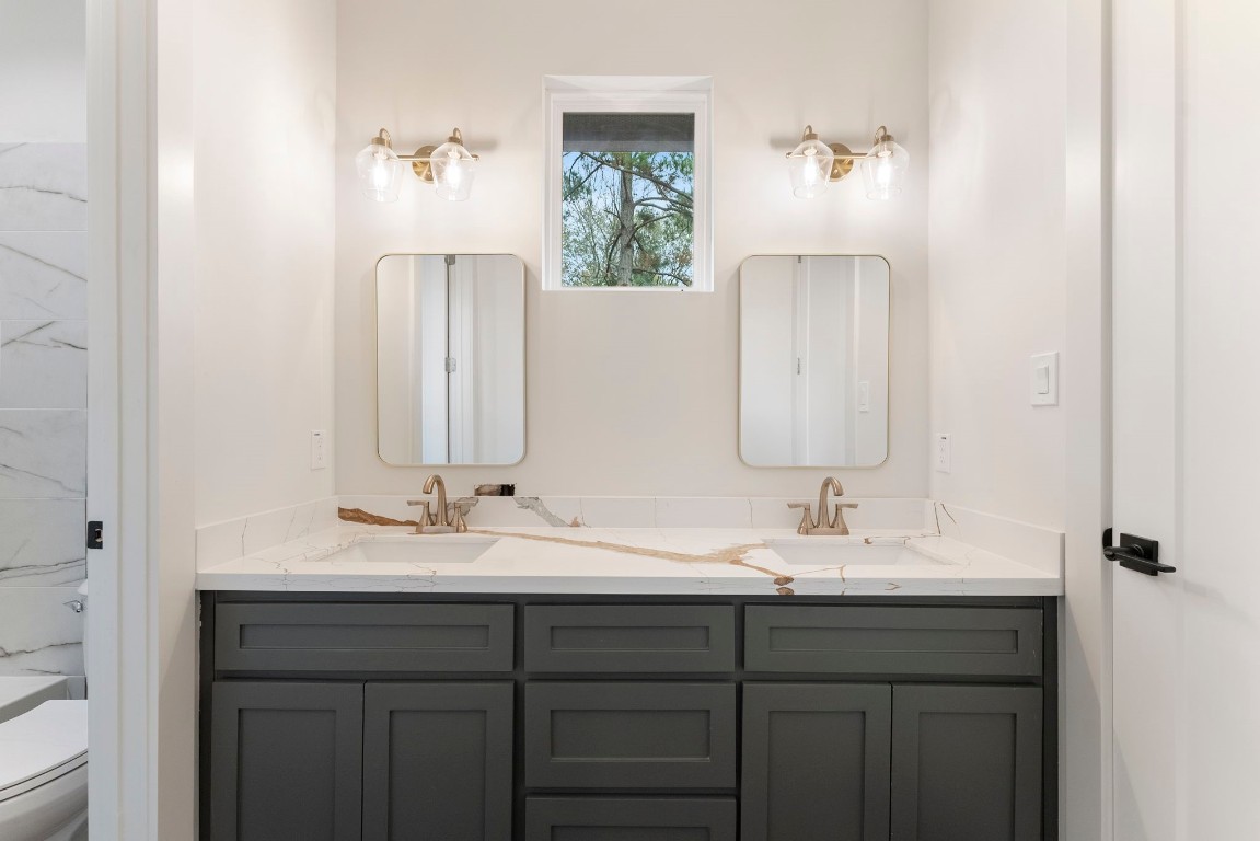 29001 Colin Court Waller, TX 77484 - Photo 29 of 47 a bathroom with a double vanity sink and a mirror