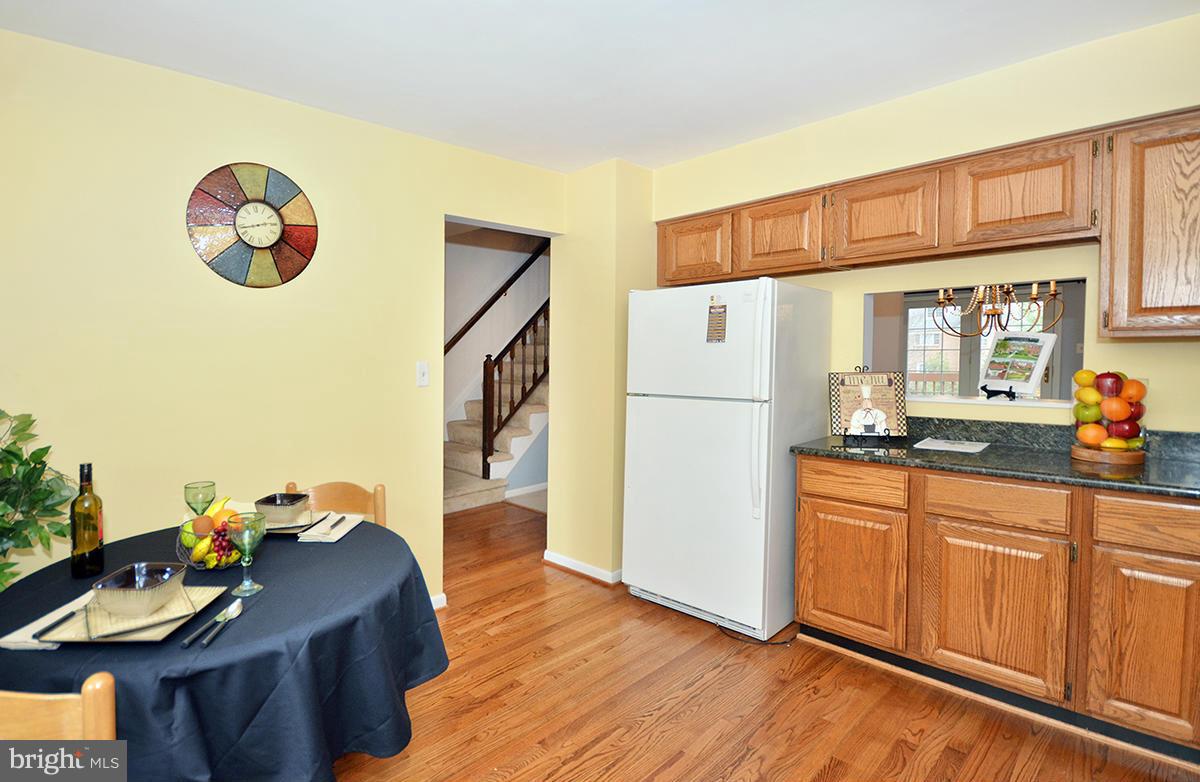 207 Castletown Road Lutherville-Timonium, MD 21093 - Photo 7 of 21 a kitchen with stainless steel appliances granite countertop a refrigerator a stove a sink and dishwasher with wooden floor