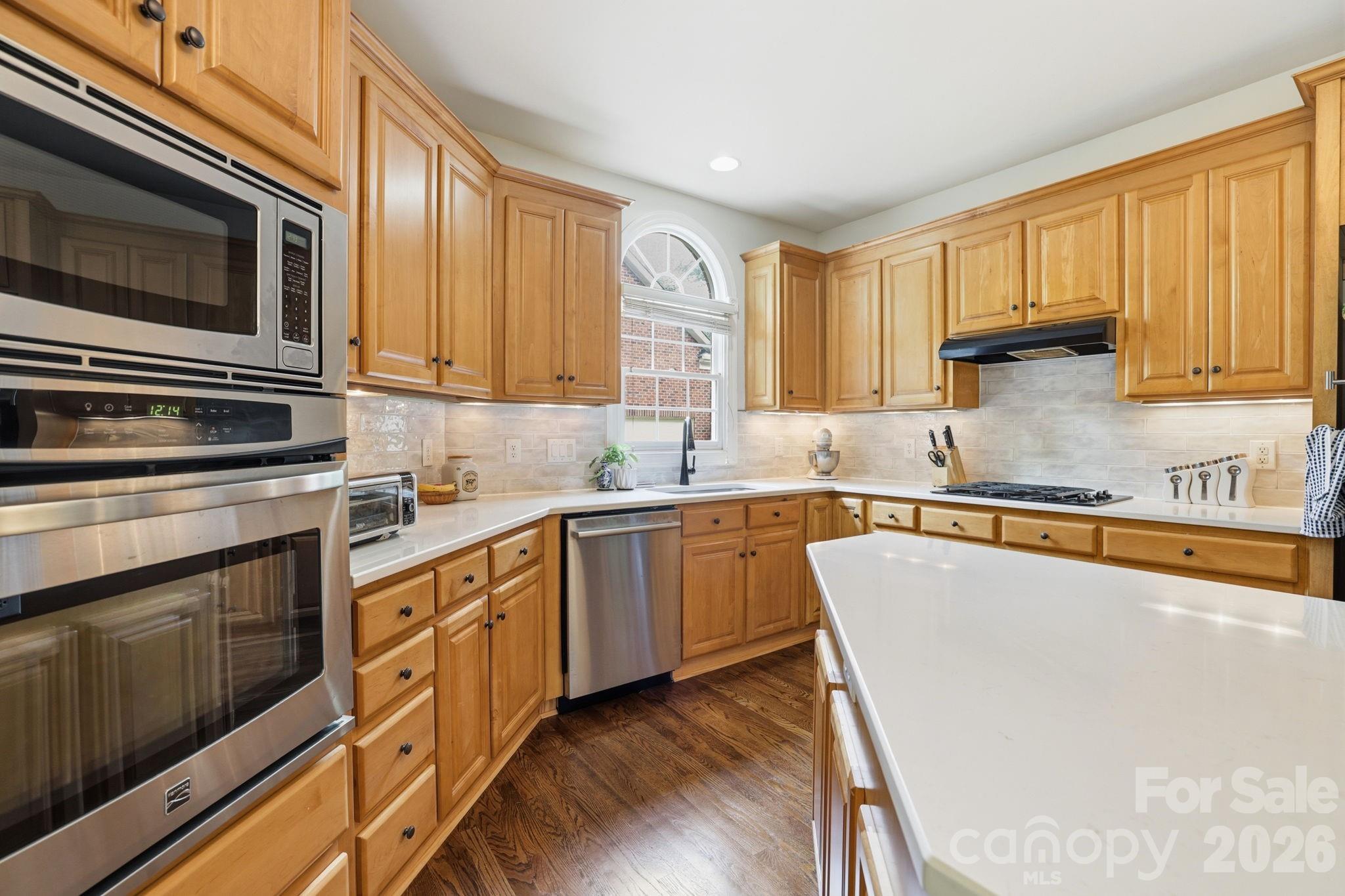 239 Sardis Pointe Road Matthews, NC 28105 - Photo 11 of 47 a kitchen with stainless steel appliances granite countertop a stove a sink and a microwave