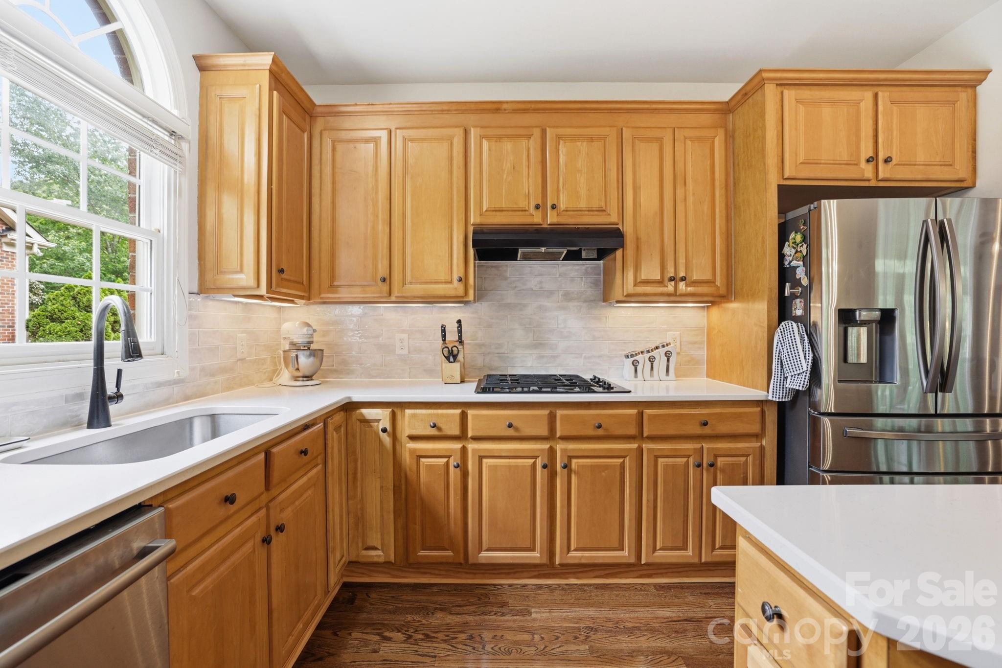 239 Sardis Pointe Road Matthews, NC 28105 - Photo 12 of 47 a kitchen with stainless steel appliances granite countertop a refrigerator sink and cabinets